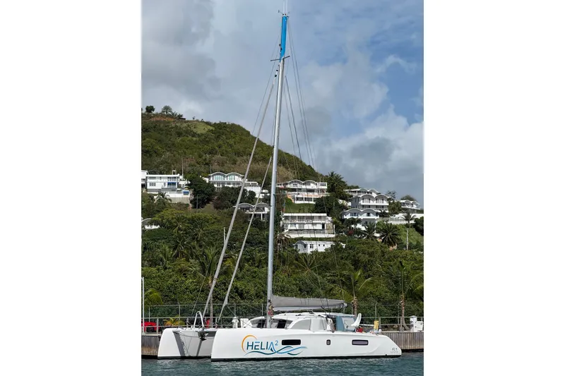 Slide: The Image of 2022 Outremer 51 catamaran docked with hillside houses in the background. - 30