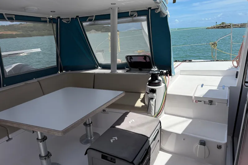 Slide: The Image of 2022 Outremer 51 yacht cockpit with seating, table, and ocean view. - 9