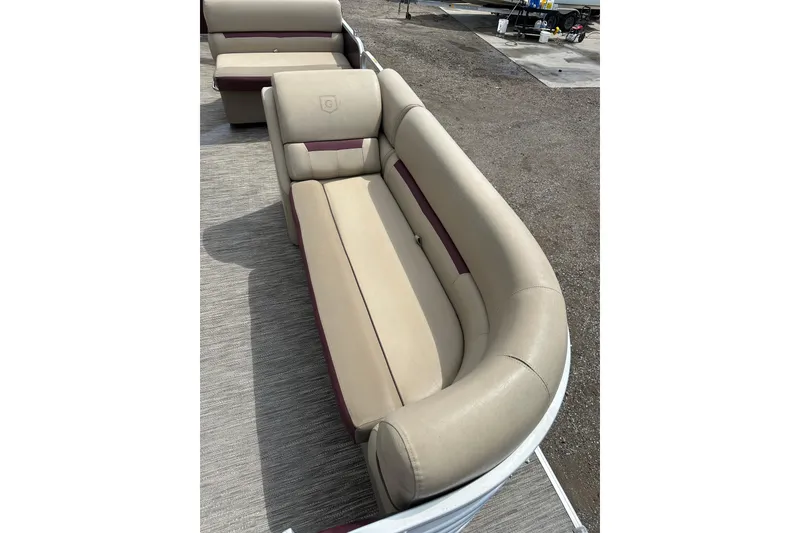 Slide: The Image of 2022 Godfrey Sweetwater 2286 SB boat seating, featuring beige and maroon upholstery on a pontoon deck. - 11