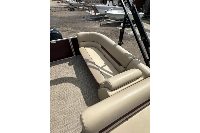 Slide: The Image of 2022 Godfrey Sweetwater 2286 SB pontoon boat with beige seating, docked outdoors. - 13