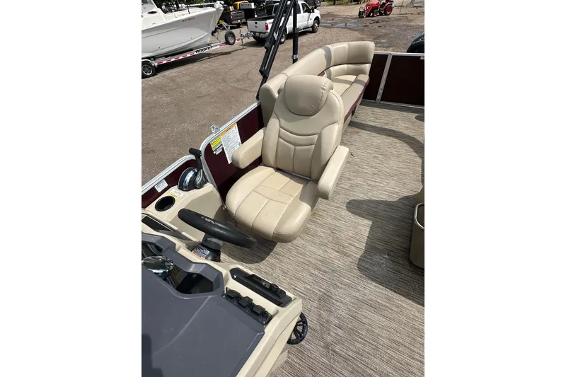 Slide: The Image of 2022 Godfrey Sweetwater 2286 SB boat interior with beige captain's chair and steering wheel. - 15