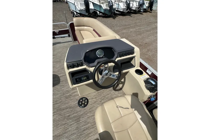 Slide: The Image of 2022 Godfrey Sweetwater 2286 SB boat interior with steering wheel and seating. - 16