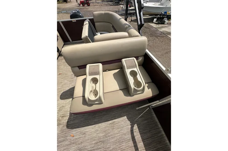 Slide: The Image of 2022 Godfrey Sweetwater 2286 SB boat interior with beige seating and cup holders. - 19