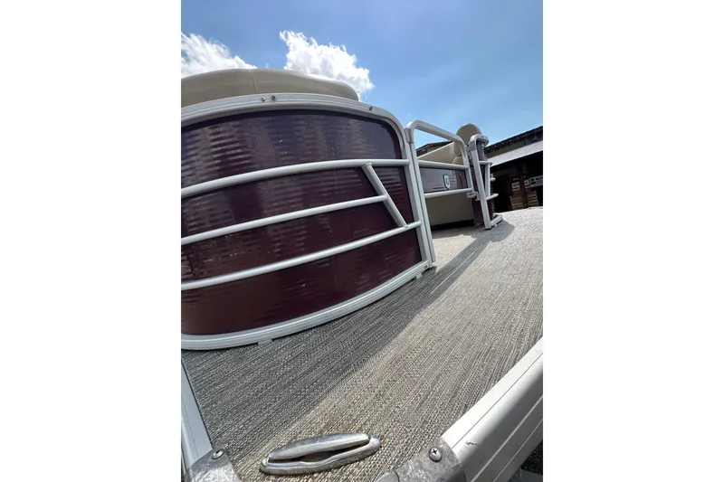Slide: The Image of 2022 Godfrey Sweetwater 2286 SB pontoon boat, close-up view under sunny sky. - 22