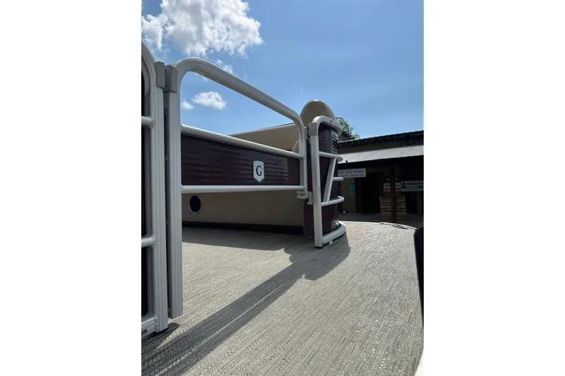 Slide: The Image of 2022 Godfrey Sweetwater 2286 SB pontoon boat deck under clear blue sky. - 23
