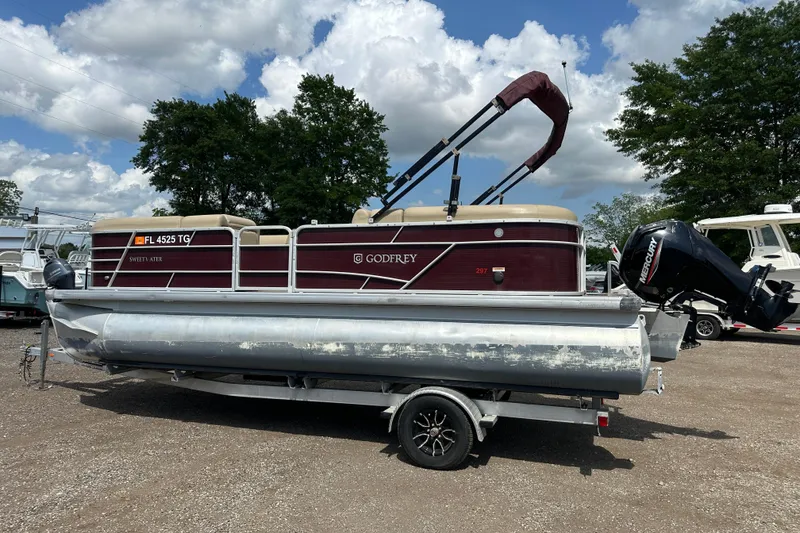 Slide: The Image of 2022 Godfrey Sweetwater 2286 SB pontoon boat on trailer, parked outdoors. - 3