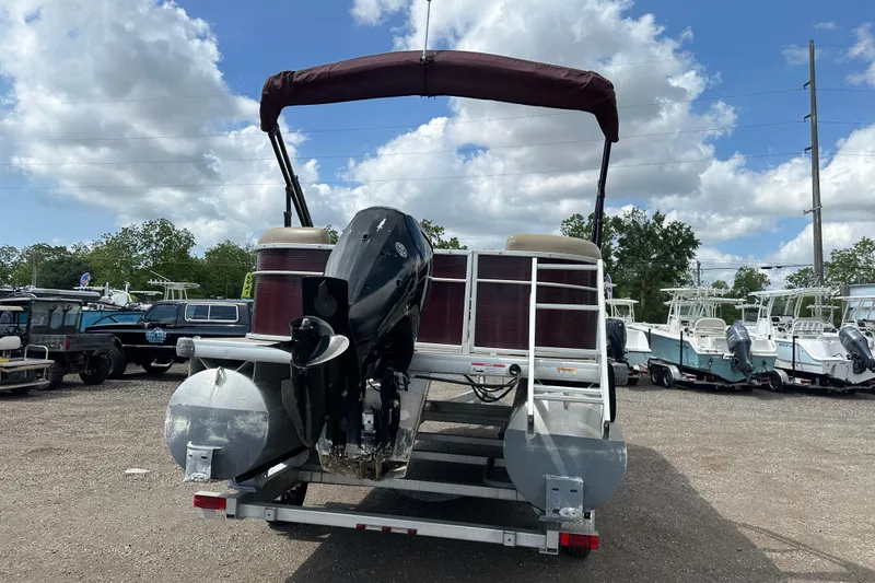 Slide: The Image of 2022 Godfrey Sweetwater 2286 SB pontoon boat on trailer, parked outdoors. - 5