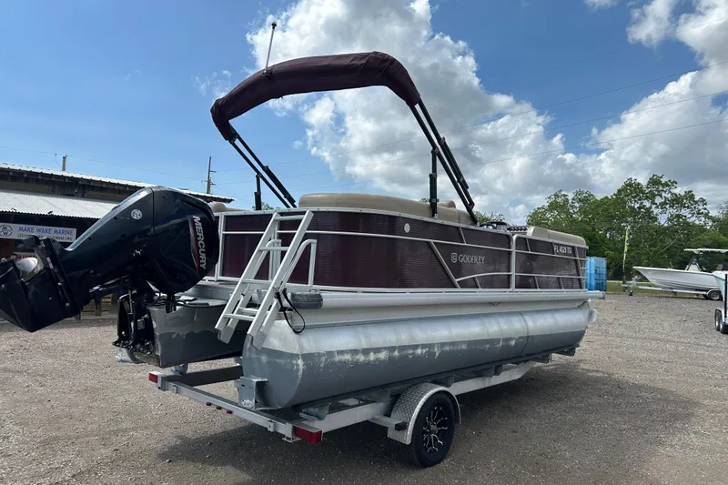 Slide: The Image of 2022 Godfrey Sweetwater 2286 SB pontoon boat on trailer, with Mercury outboard motor. - 6