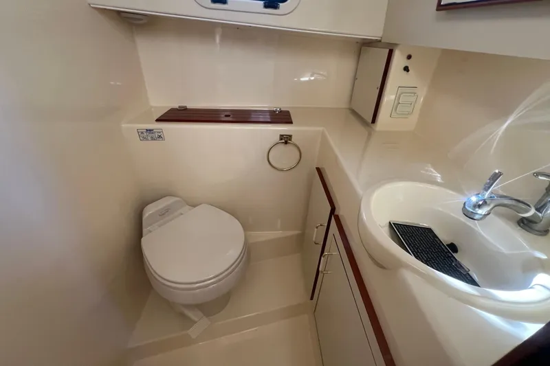 Slide: The Image of 2005 Camano Trawler bathroom with toilet, sink, and storage cabinets. - 20