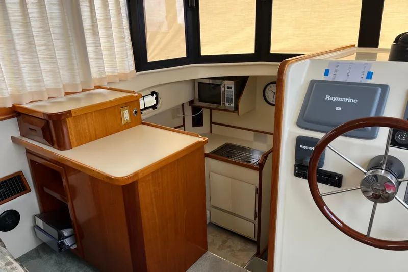 Slide: The Image of 2005 Camano Trawler interior with helm, kitchen, and navigation equipment. - 22