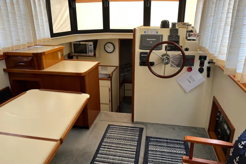 Slide: The Image of 2005 Camano Trawler interior with helm, dining area, and navigation equipment. - 23