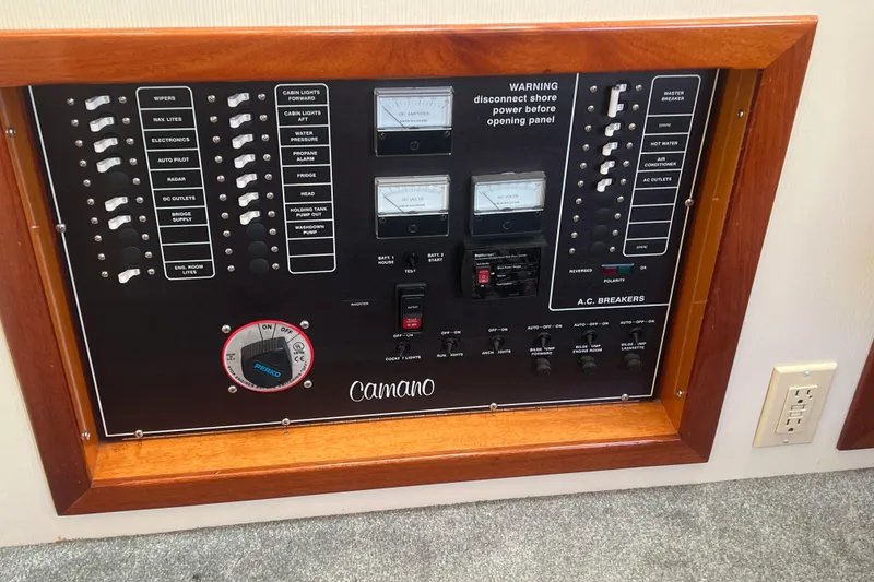 Slide: The Image of Electrical control panel of a 2005 Camano Trawler boat with various switches and meters. - 31