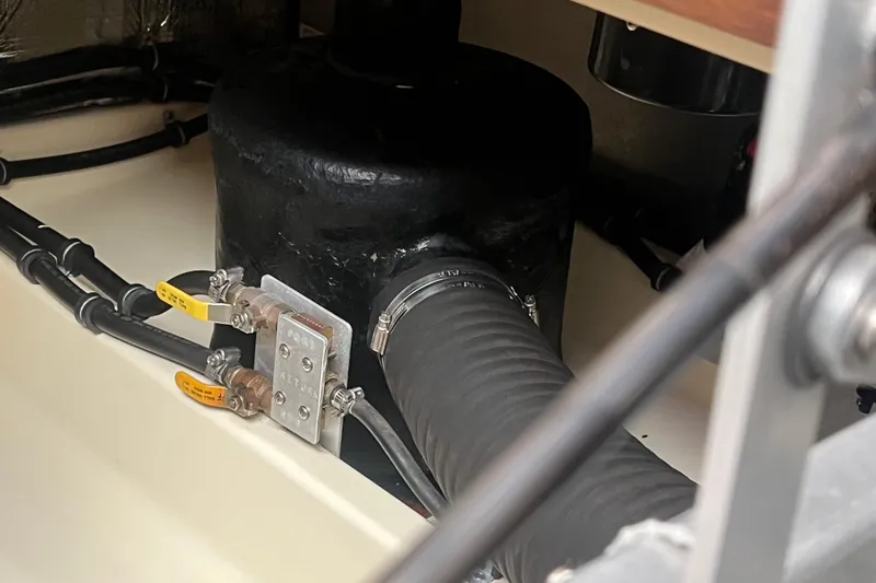 Slide: The Image of Engine compartment of a 2005 Camano Trawler, featuring hoses and valves. - 33