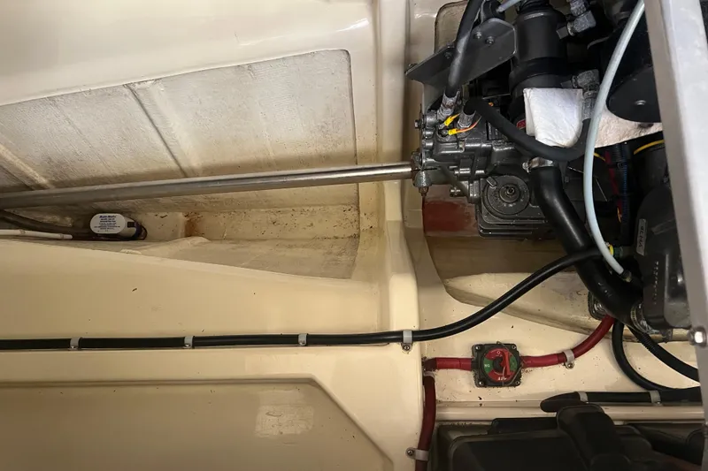 Slide: The Image of Engine compartment of a 2005 Camano Trawler, showcasing mechanical components and wiring. - 35