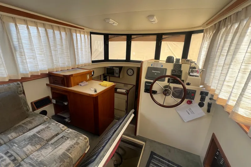 Slide: The Image of 2005 Camano Trawler interior with helm, steering wheel, and navigation equipment. - 7