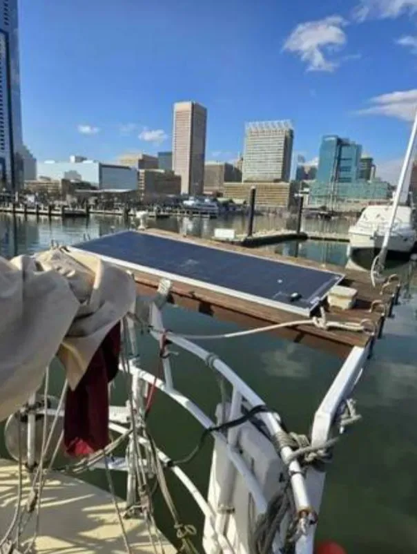 Slide: The Image of 1979 Colvin Gazelle with solar panel docked in city harbor. - 11