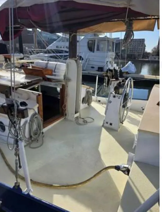 Slide: The Image of 1979 Colvin Gazelle sailboat in harbor, featuring wheel and rigging. - 12