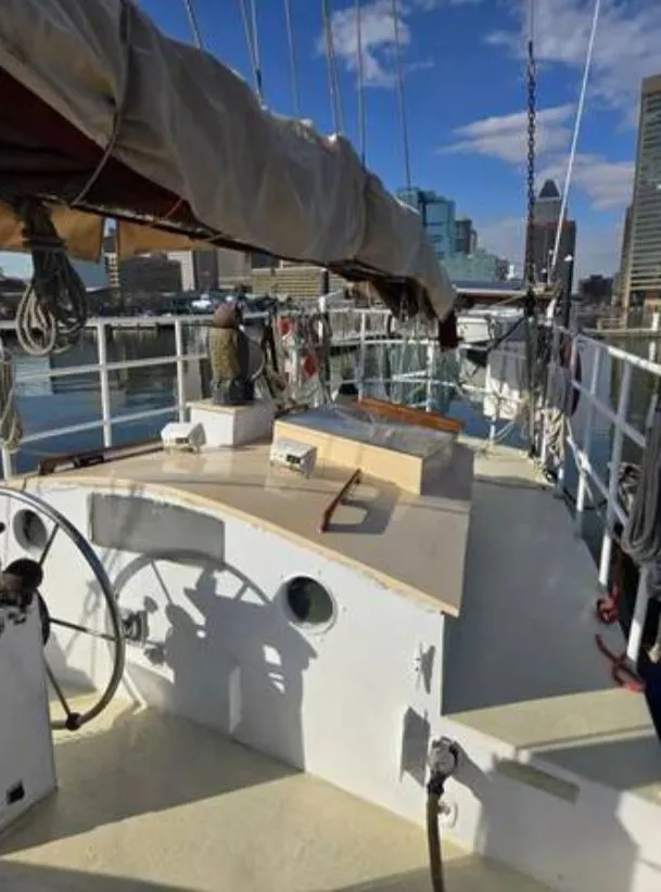 Slide: The Image of 1979 Colvin Gazelle sailboat docked with city skyline view. - 15