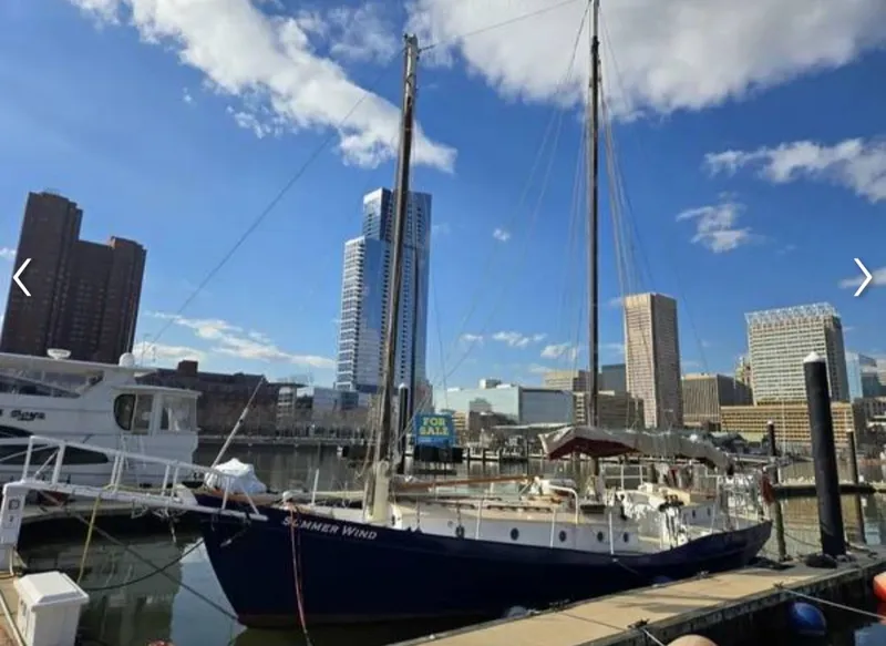 Slide: The Image of 1979 Colvin Gazelle sailboat docked with city skyline view. - 16