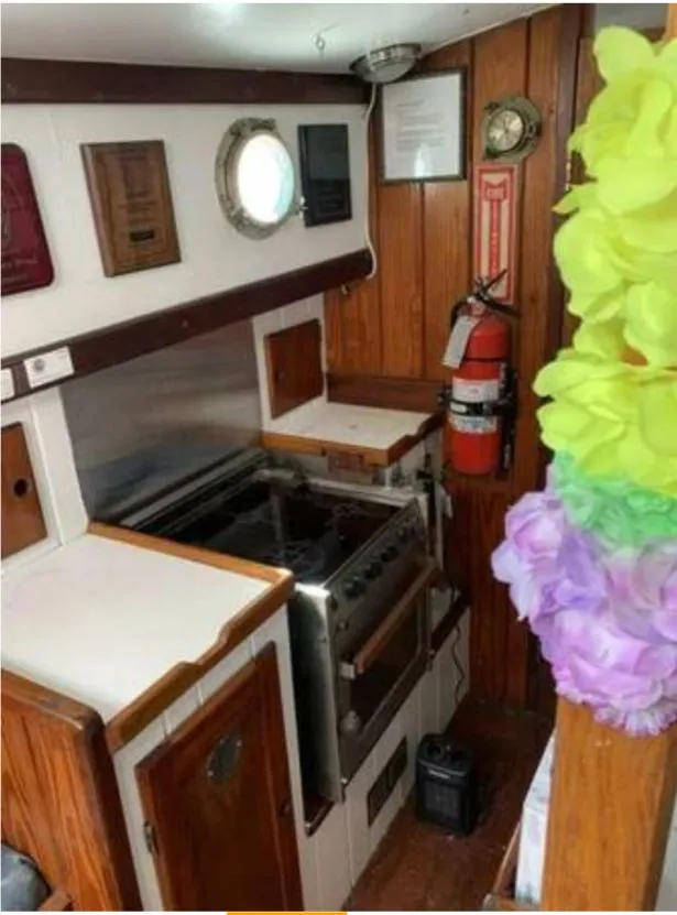 Slide: The Image of Interior of a 1979 Colvin Gazelle with wood paneling and stove. - 4