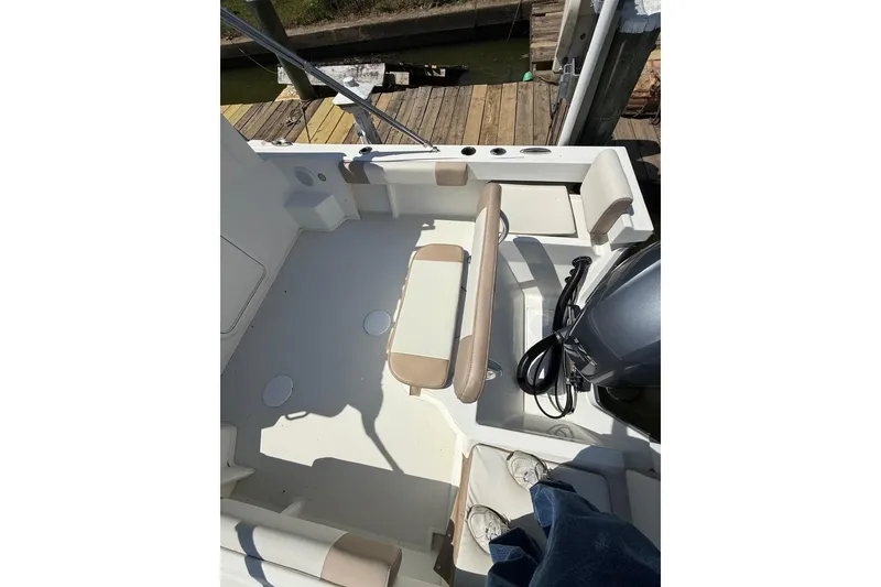 Slide: The Image of 2019 Parker 2150 boat interior with seating and engine view. - 12