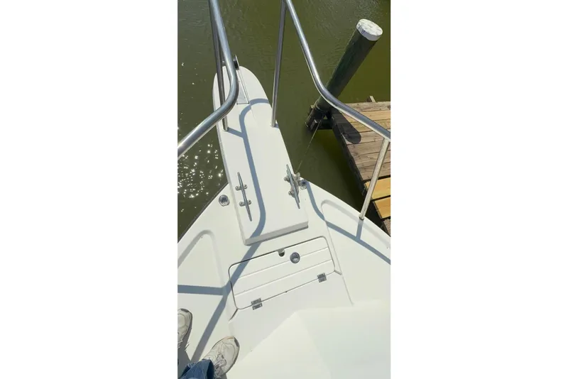 Slide: The Image of Bow of a 2019 Parker 2150 boat docked by a pier. - 13