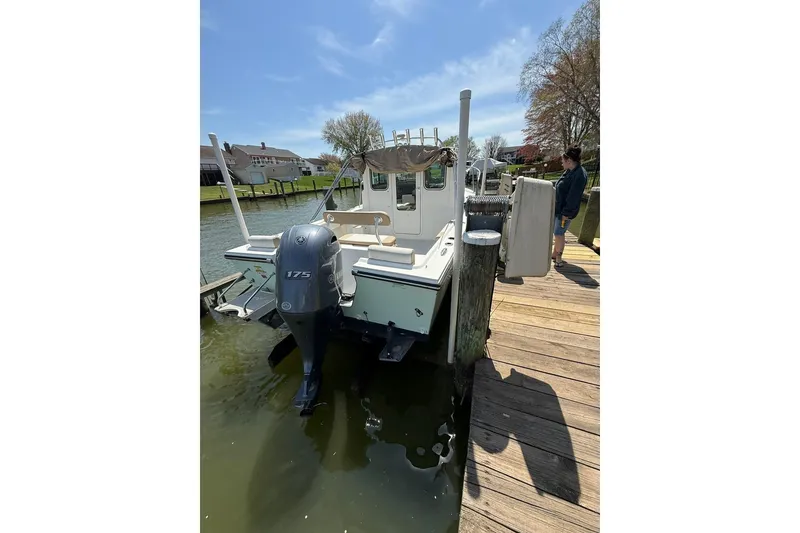 Slide: The Image of 2019 Parker 2150 boat docked with 175 horsepower outboard motor. - 3