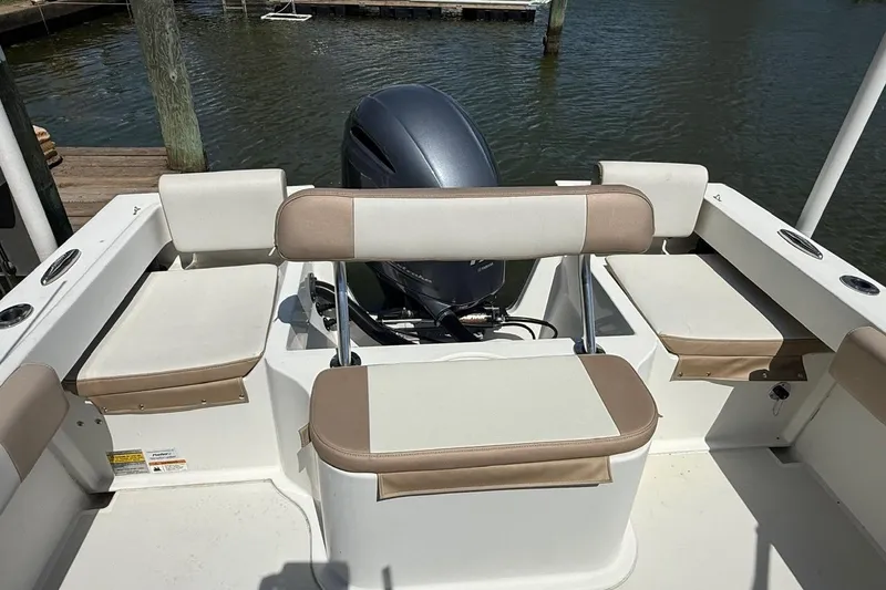 Slide: The Image of 2019 Parker 2150 boat interior with cushioned seating and outboard motor. - 6