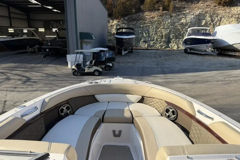 Slide: The Image of 2014 Regal 2700 ES Bowrider boat interior at a marina with other boats. - 11