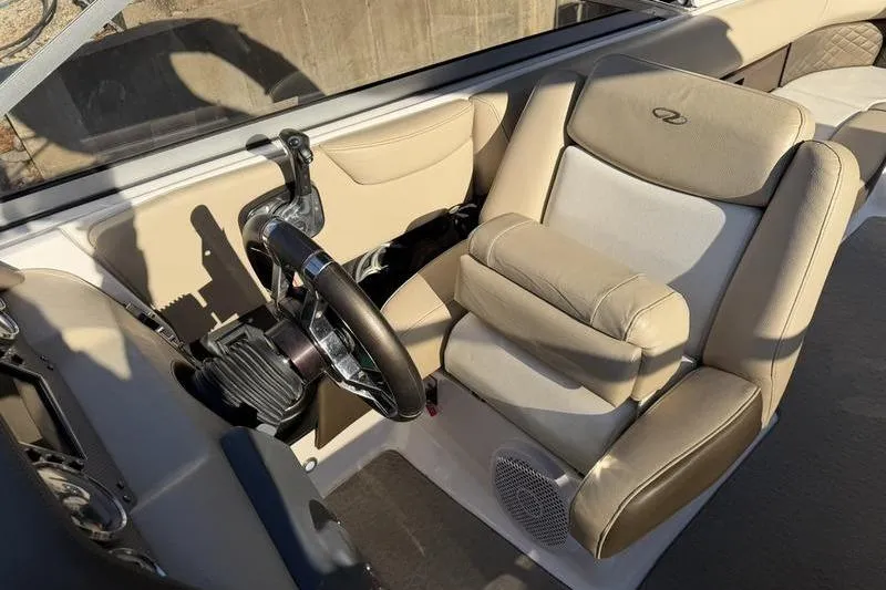 Slide: The Image of 2014 Regal 2700 ES Bowrider interior with beige seating and steering wheel. - 13