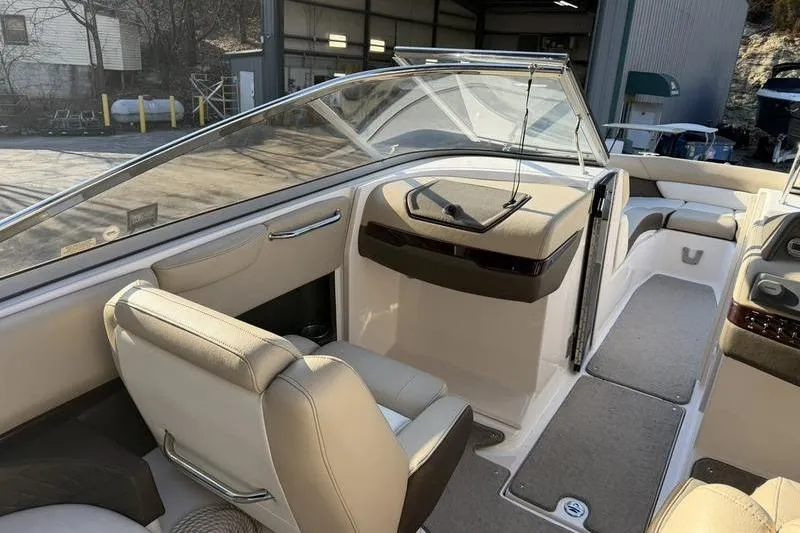Slide: The Image of 2014 Regal 2700 ES Bowrider interior with beige seating and sleek design. - 14