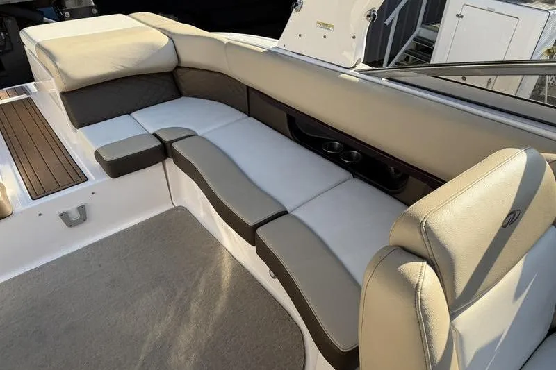 Slide: The Image of Luxurious seating area on a 2014 Regal 2700 ES Bowrider boat, featuring plush cushions. - 18