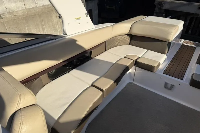 Slide: The Image of 2014 Regal 2700 ES Bowrider interior with beige seating and wood accents. - 19