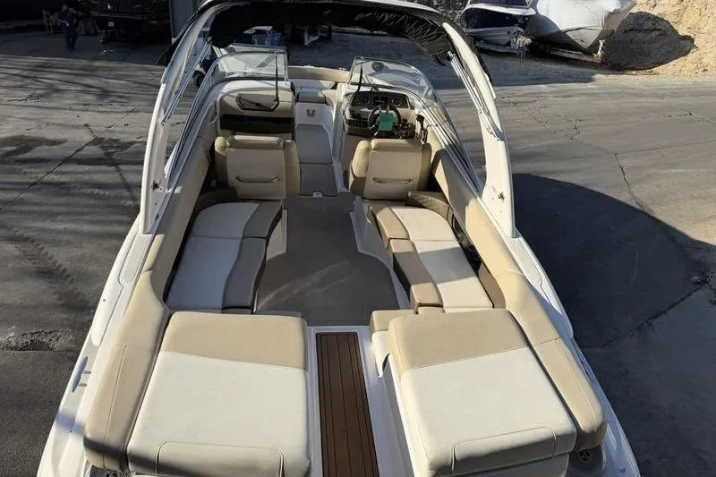 Slide: The Image of 2014 Regal 2700 ES Bowrider boat interior with beige seating and sleek design. - 20