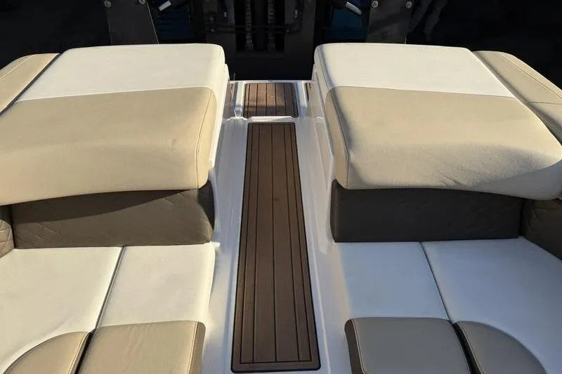 Slide: The Image of 2014 Regal 2700 ES Bowrider interior with beige and white seating, wooden flooring. - 21