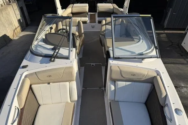 Slide: The Image of 2014 Regal 2700 ES Bowrider boat interior with beige seating and dual windshields. - 22