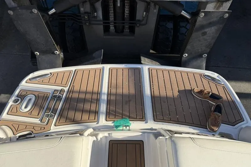 Slide: The Image of 2014 Regal 2700 ES Bowrider swim platform with shoes and teak decking. - 25