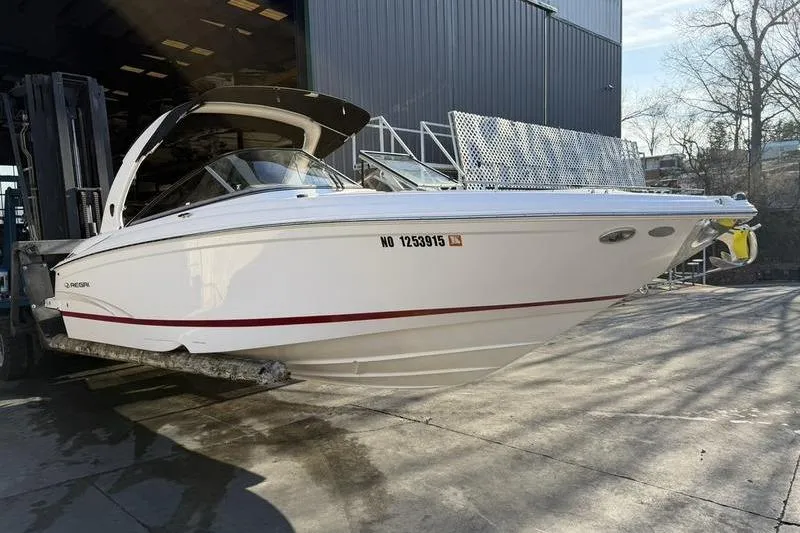 Slide: The Image of 2014 Regal 2700 ES Bowrider boat on forklift near warehouse. - 4