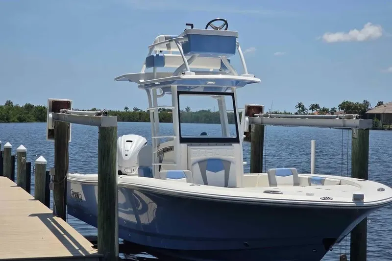 The Image of 2023 Robalo 266 Cayman SD boat docked on a sunny day by the water. - 0