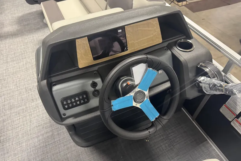 Slide: The Image of Steering console of 2026 Sun Tracker Fishin' Barge 20 DLX with modern controls. - 11