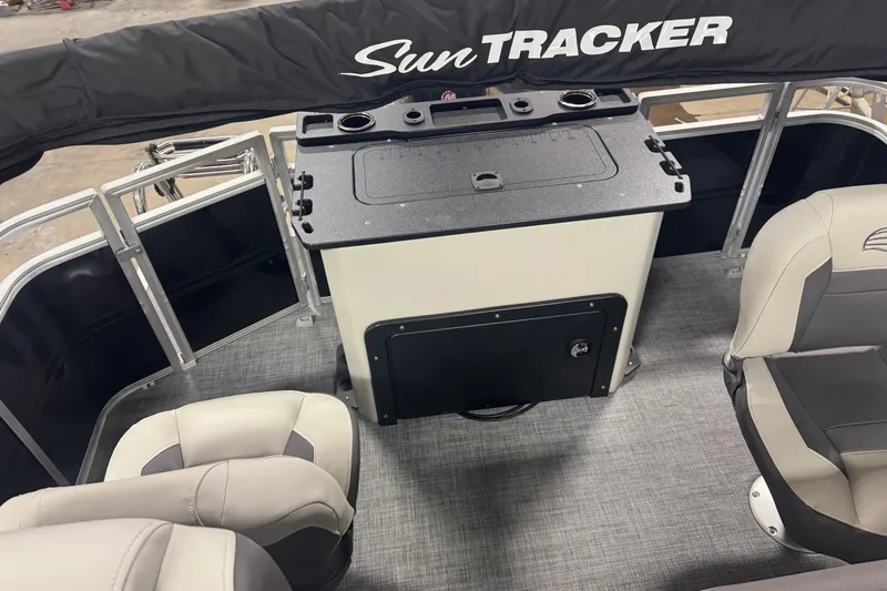 Slide: The Image of 2026 Sun Tracker Fishin' Barge 20 DLX interior with seating and storage area. - 13