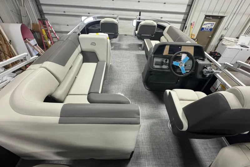 Slide: The Image of 2026 Sun Tracker Fishin' Barge 20 DLX interior with plush seating and modern helm. - 15