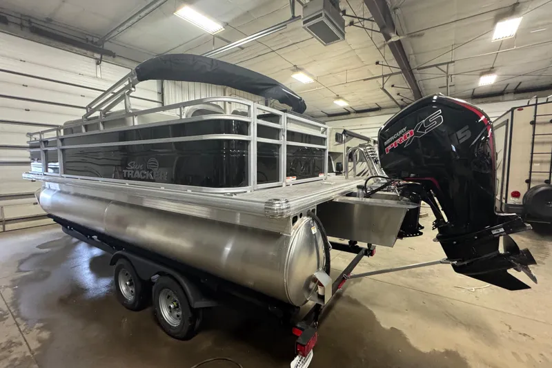 Slide: The Image of 2026 Sun Tracker Fishin' Barge 20 DLX pontoon boat in indoor storage. - 4