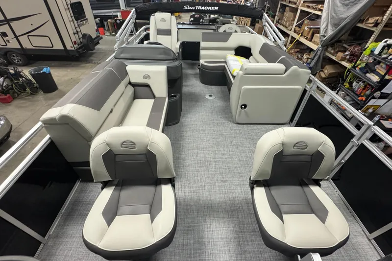 Slide: The Image of 2026 Sun Tracker Fishin' Barge 20 DLX interior with gray and beige seating. - 5