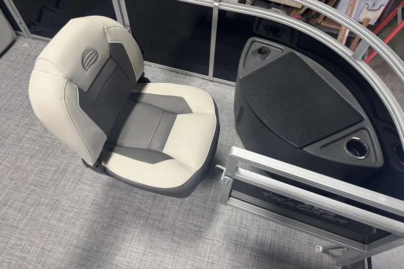 Slide: The Image of 2026 Sun Tracker Fishin' Barge 20 DLX interior with cushioned seat and console. - 7