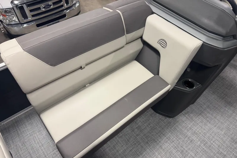 Slide: The Image of 2026 Sun Tracker Fishin' Barge 20 DLX interior seating with gray and beige upholstery. - 8