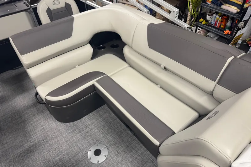Slide: The Image of 2026 Sun Tracker Fishin' Barge 20 DLX interior seating with gray and beige upholstery. - 9