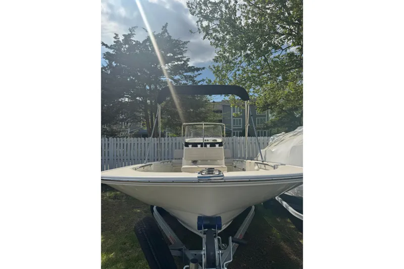 Slide: The Image of 2026 Boston Whaler 170 Montauk boat on trailer, parked outdoors. - 29