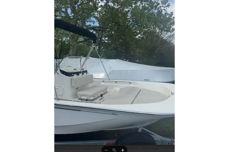 Slide: The Image of 2026 Boston Whaler 170 Montauk boat with seating, parked outdoors. - 36