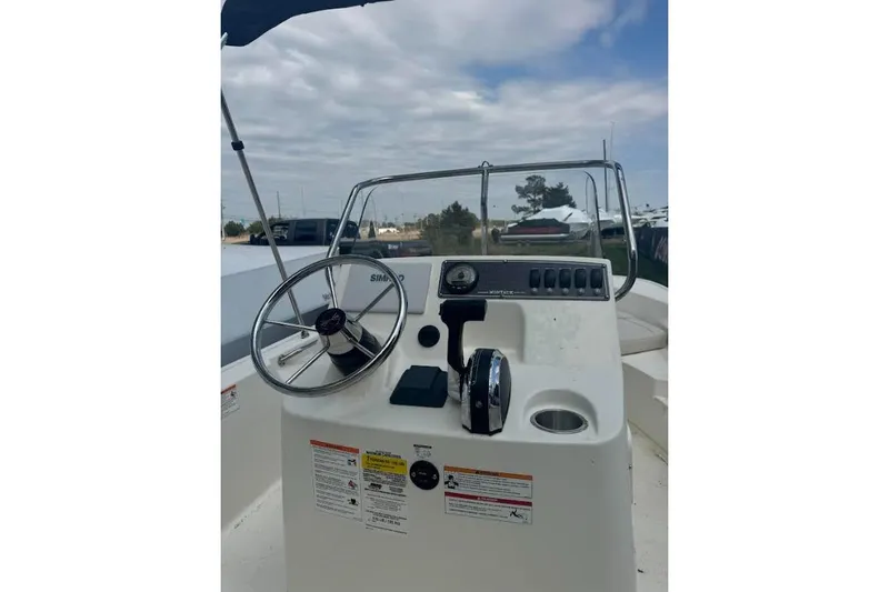 Slide: The Image of 2026 Boston Whaler 170 Montauk boat console with steering wheel and controls. - 37